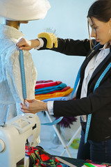 Couturier sews a dress