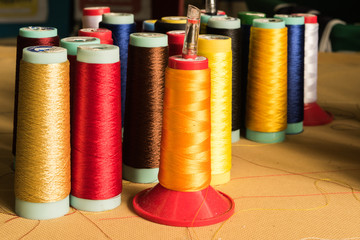 thimble and spools of thread on desk