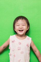 Happy asian girl smiling on green background