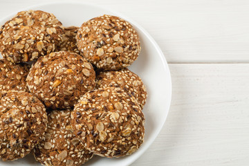 Oatmeal cookies in white ceramic plate on a white wooden table, copy space