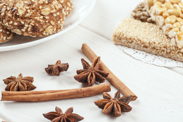 Cinnamon sticks with star anise on a white wooden table with sweet dessert on it