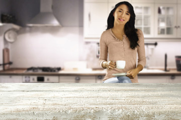 woman with coffee in kitchen 