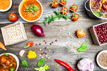 Vegetable Soups with Cooking Ingredients on Wooden Table Background