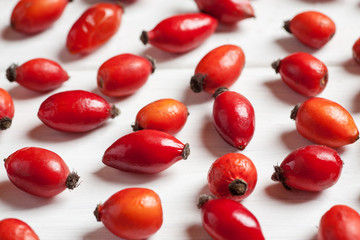 Close-up shot od rosehip berries on a wooden table