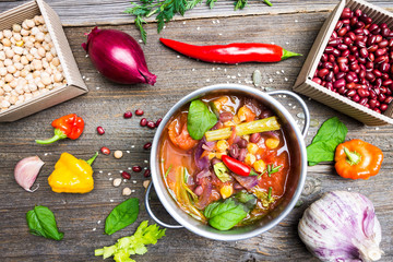 Colorful Food Background. Bio Vegetable Soup with Chickpea and Adzuki Beans in Pot with Cooking Ingredients on Wooden Table.