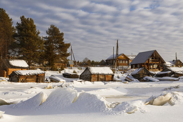 View from the frozen Bay of the White Sea on the village Nilmoguba, Karelia, Russia