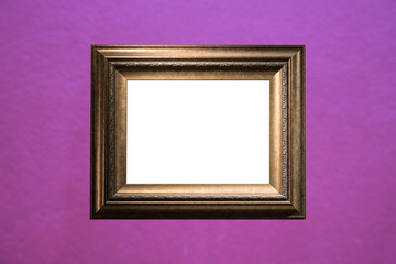 Blank golden frame on purple cement wall