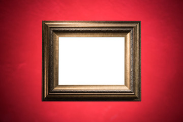 Blank golden frame on red cement wall