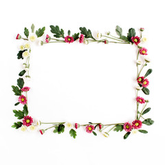 Frame wreath with red and white wildflowers, green leaves, branches on white background. Flat lay, top view. Flower background.