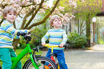 Fototapeta premium Adorable little kid boy driving his first bike or laufrad