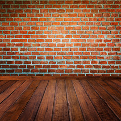 Red brick wall with wooden floor