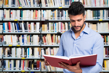 Smiling man reading a book