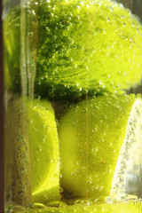 cold drink from a fresh lime with bubbles in a goblet on a black background