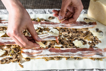 Filling dough with a stuffing. Preparing puff pastry rolls, baking concept
