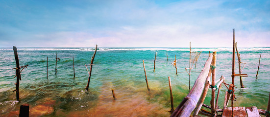 Fototapeta na wymiar Wooden fishing bridge on the ocean coast