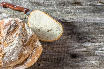 Fresh baked bread loaf on rustic wooden table, baking concept