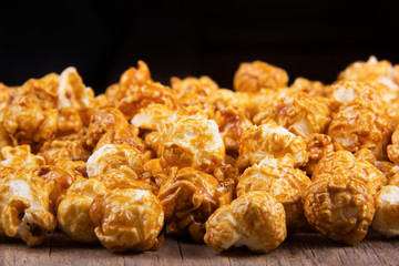 Golden caramel popcorn closeup. Background of popcorn. Unhealthy food