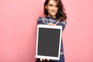 Woman holding a tablet with empty black screen