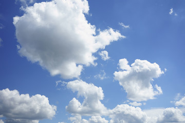 the white clouds floating on a background of blue sky