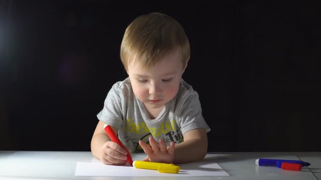 Little Boy Draws With Colored Markers
