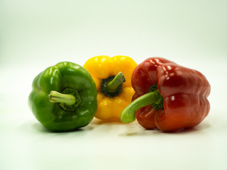 Green, Yellow and Red paprika on white background, sweet pepper, bell pepper