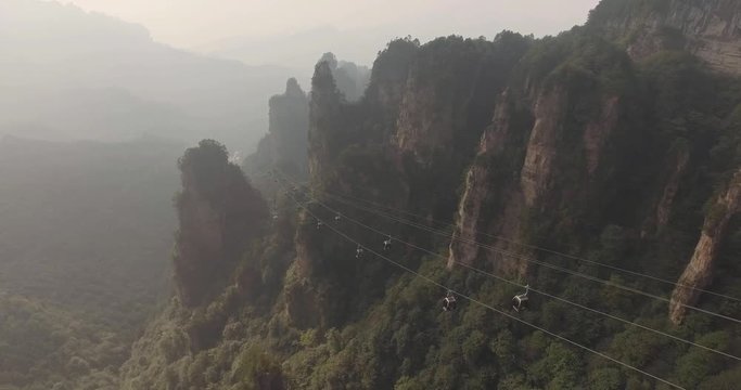Aerial view of moving cable cars with mist in Tianmen mountain Zhangjiajie National Park, Hunan province, China.