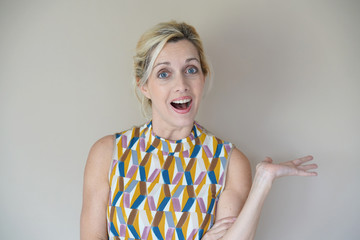 Blond woman expression on beige background, isolated