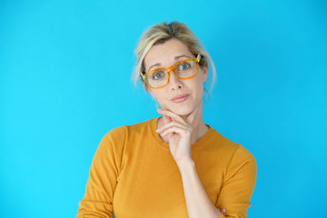 Portrait of blond woman with eyeglasses being astonished, isolated