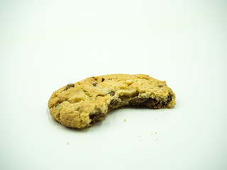 Chocolate chip cookie and crumbs on white background