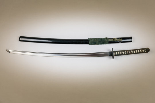 Japanese sword isolated on white. Iaido training sword iaito. Studio shot white light in center.