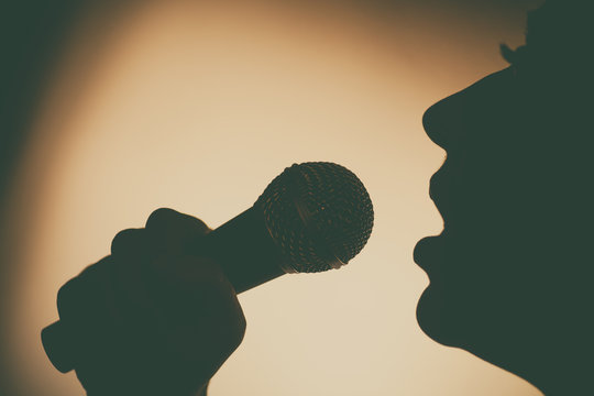 Woman singing to microphone