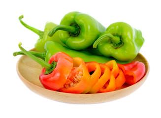 Sweet pepper in wooden dish isolated on  white background
