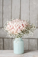 Pink chrysanthemum flower with gypsophila paniculata twigs.