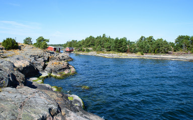 Fototapeta na wymiar Fisherman huts at the Scandinavian east coast in Summer