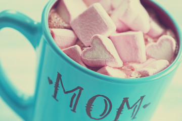 Blue cup of hot chocolate with heart marshmallows for Mom