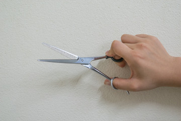 woman hand holding metal scissors