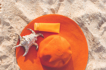 Jar of sunscreen lotion on the sandy beach