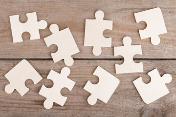 Wooden puzzle pieces on a wooden background