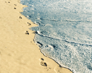 Footprint on sand with foam