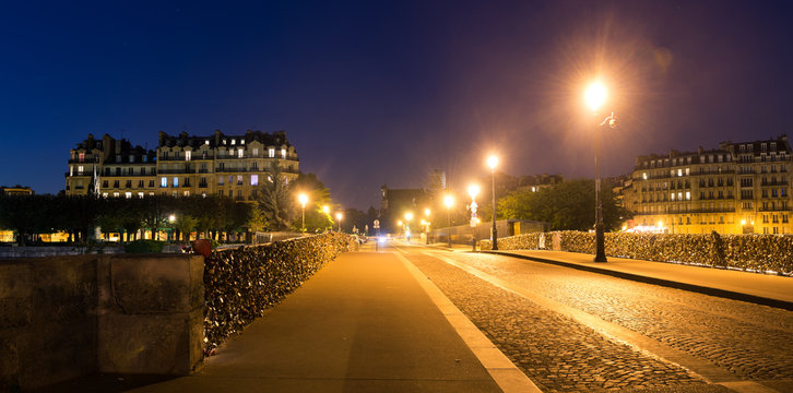 "Pont de la Tournelle" bridge at night in Paris, France
