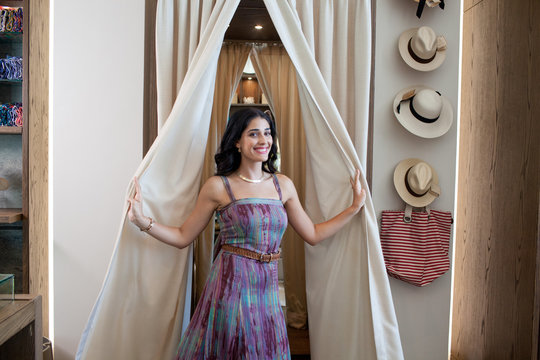 Portrait of woman at dressing room of boutique.