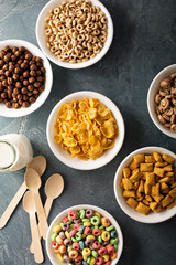 Variety of cold cereals in white bowls