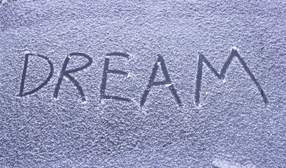 Dream inscription on snowy glass