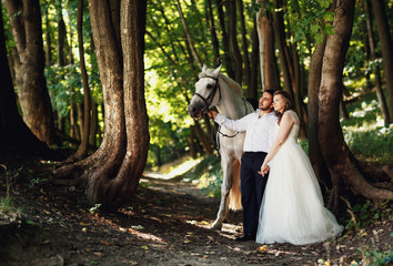 The happinest brides hold hands  in the forest