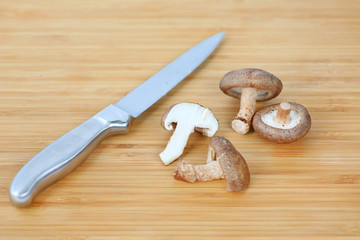 Sharp knife and Shiitake mushroom on wooden block