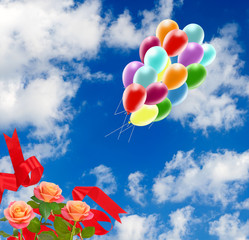 Image of beautiful flowers and colorful balloons on sky background.
