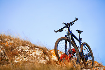 Naklejka na ściany i meble Mountain bike after ride in nature with backpack.
