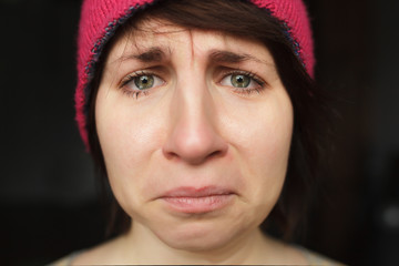 Girl cries in frustration. Tears streaming down her thick cheeks