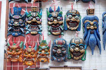 Fototapeta premium Wooden Chinese masks on sale at a souvenir market near Yu Garden, Shanghai