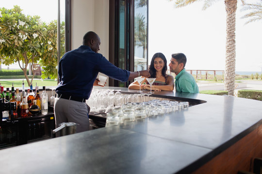 Expat couple sitting at bar area.